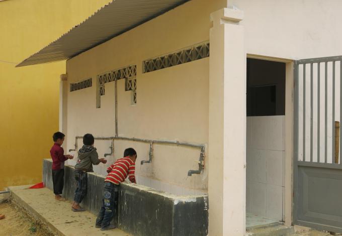 Su's students using the school's new latrine and hand washing facilities which were built as part of the program's efforts to promote hygiene habits. 